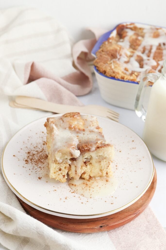 Cinnamon roll dump cake piece on plate.