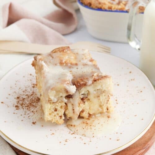 Close up of cinnamon roll dump cake piece on plate.
