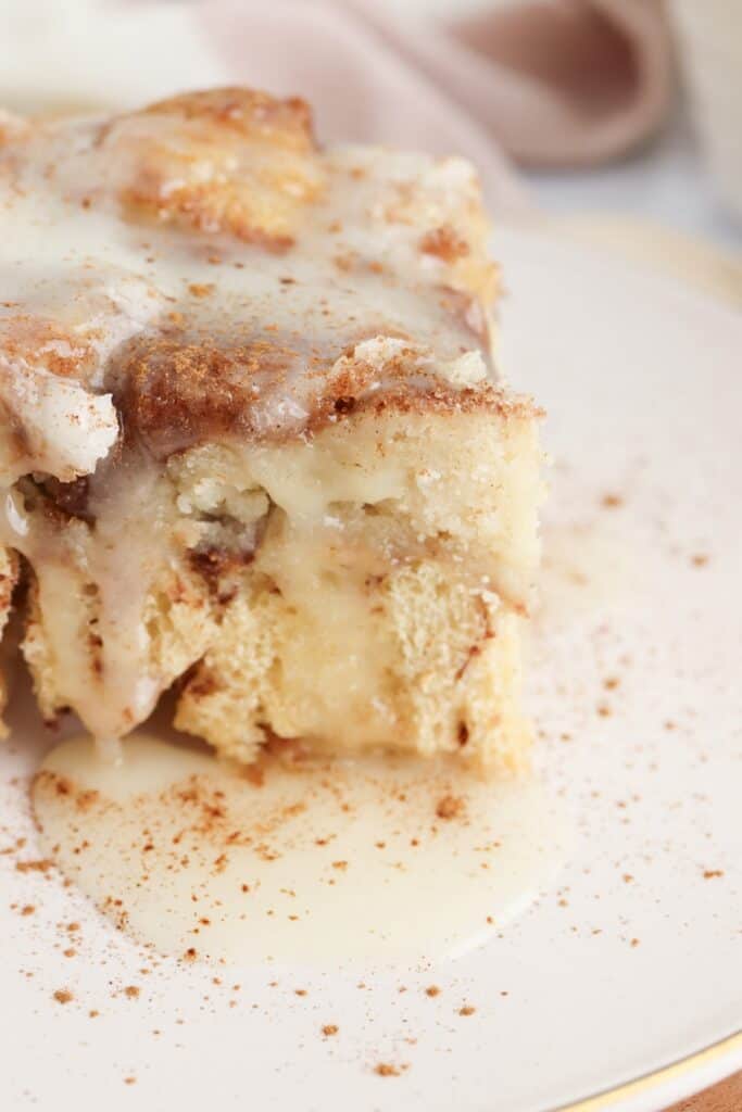 Off-center shot of cinnamon roll dump cake piece on plate.