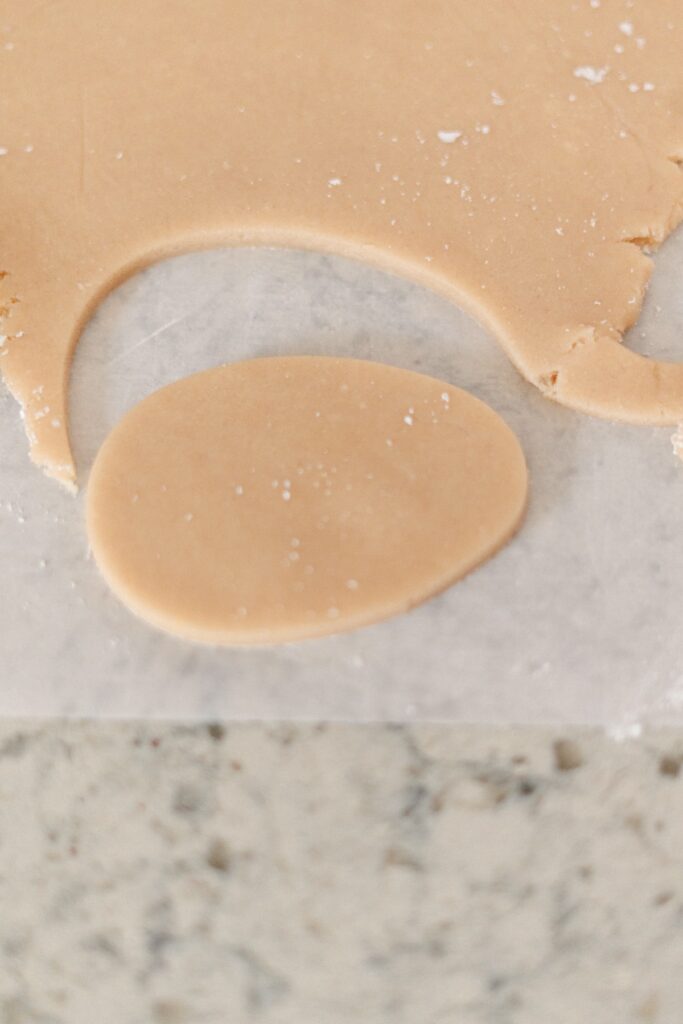 Easter Sugar Cookies dough cut out in one eg-shaped cookie piece ready to bake.
