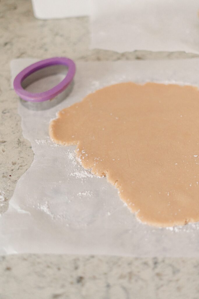 Easter sugar cookie dough and Easter egg shaped cookie cutter.