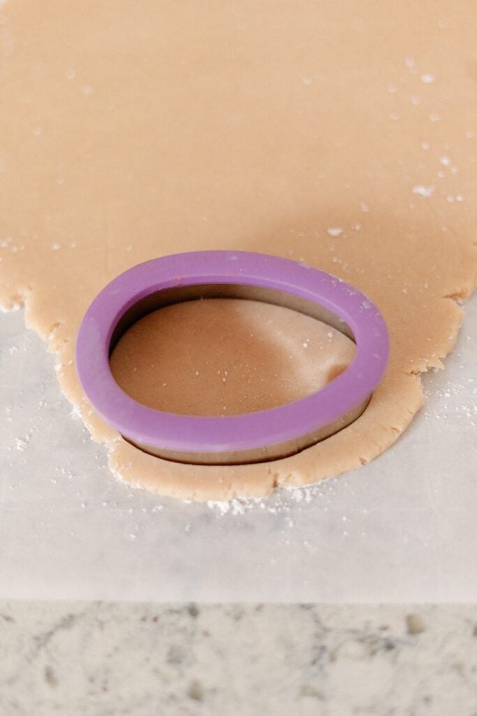Easter sugar cookie dough and Easter egg shaped cookie cutter.