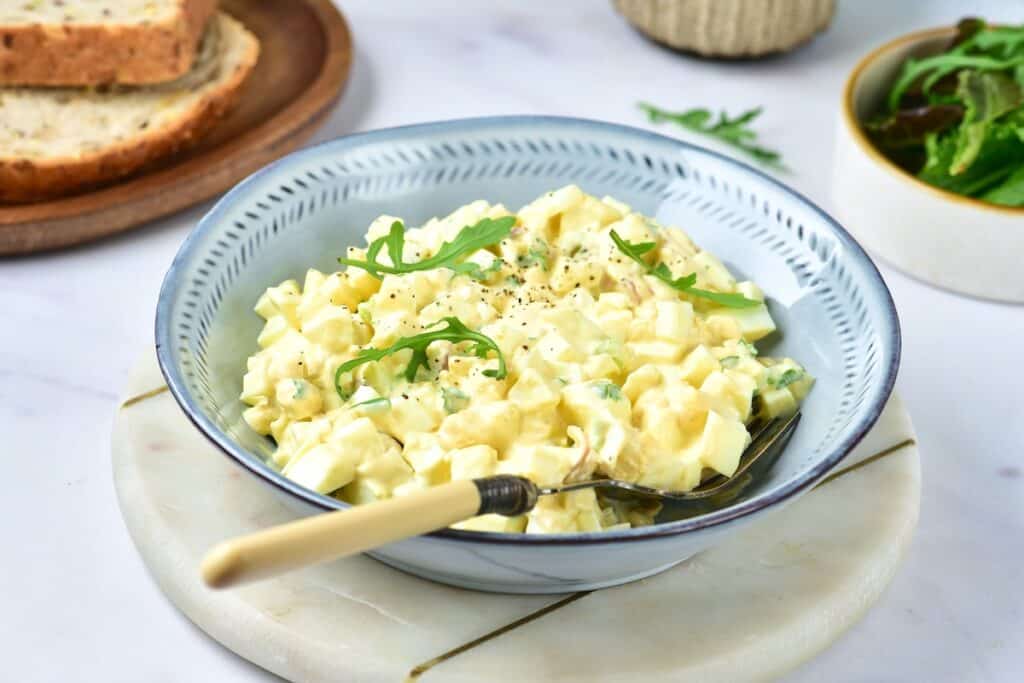 Egg salad in blue serving bowl.