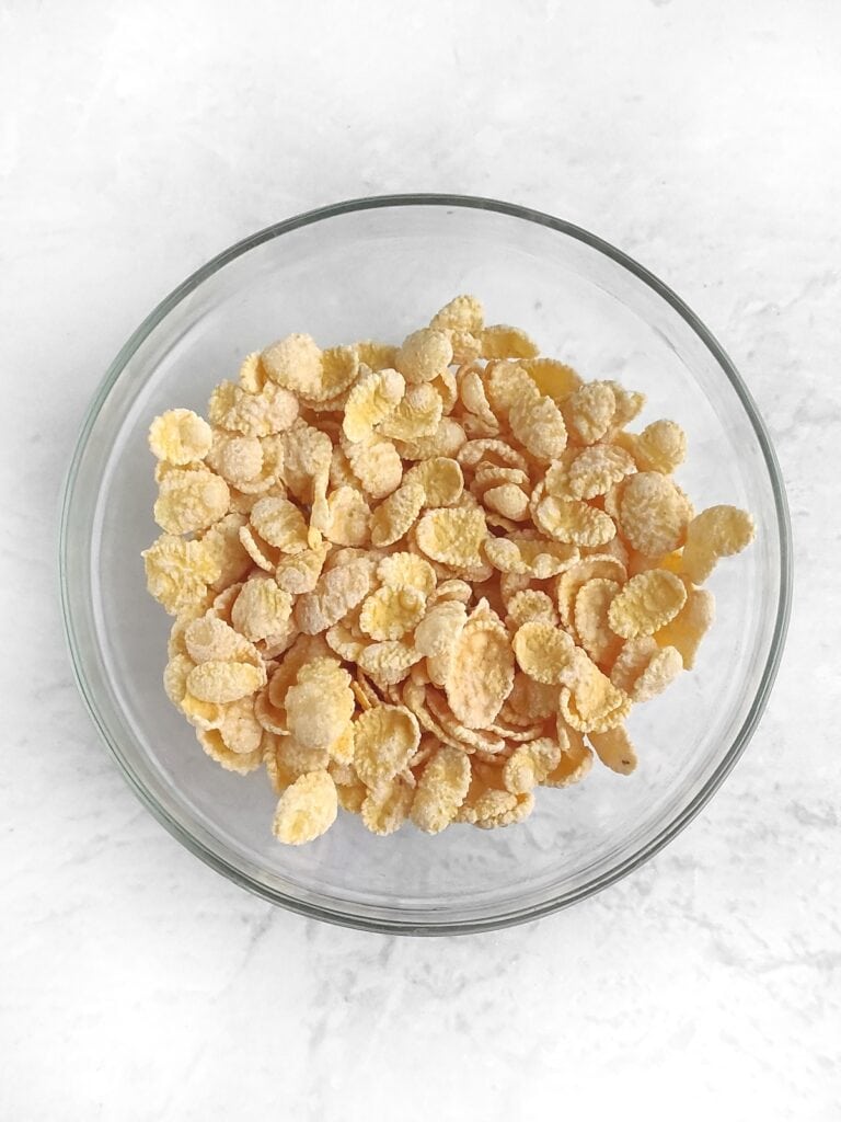Frosted corn flakes in mixing bowl, overhead shot.