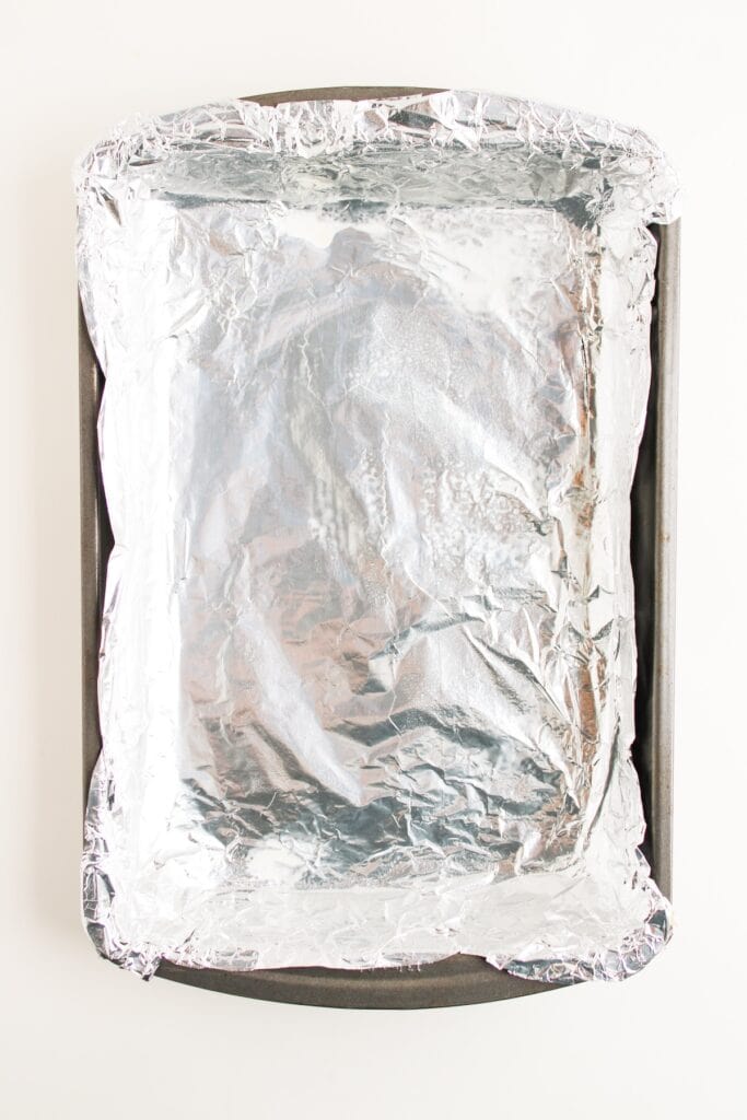 9 x 13 inch baking pan lined with aluminum foil, overhead shot.