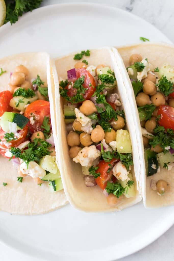 Chickpea Salad in tortillas on white plate.