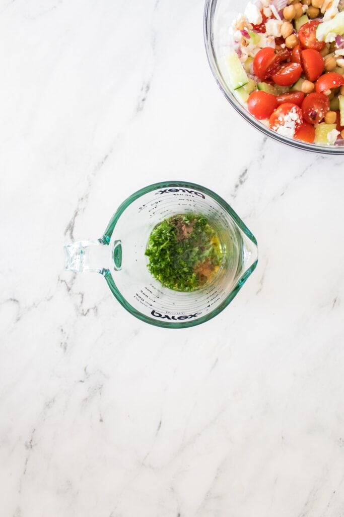 Chickpea Salad dressing, overhead shot in measuring cup.