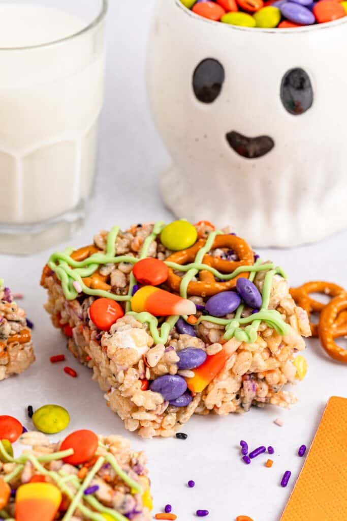 Halloween Rice Krispie Treats, closeup of one piece with milk and ghost mug.