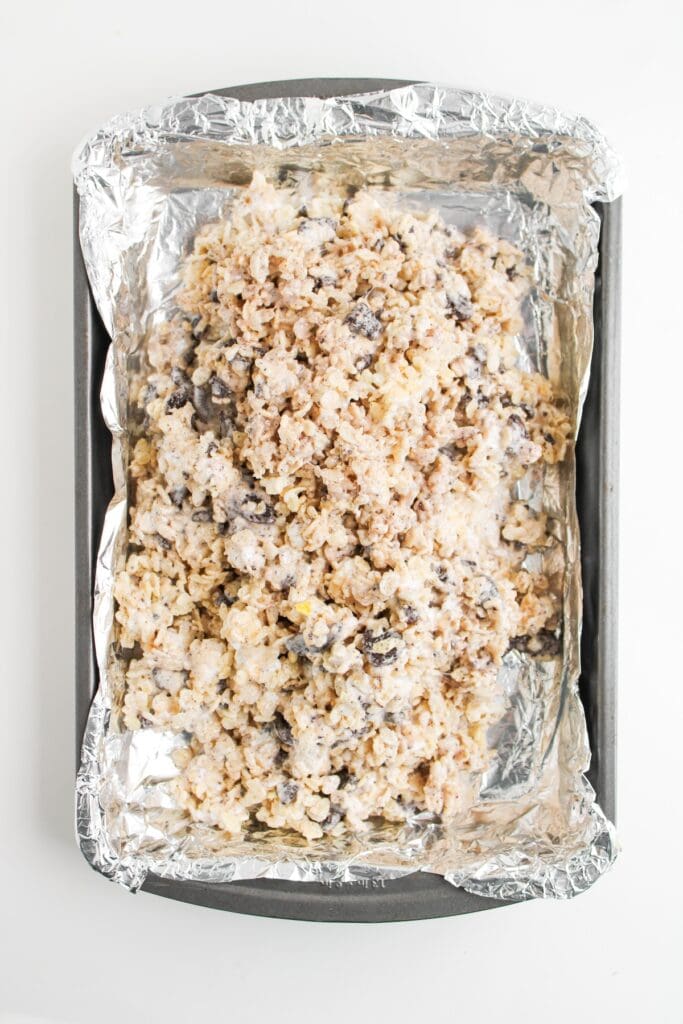Orea Rice Krispies mixture in foil-lined baking pan, overhead shot.
