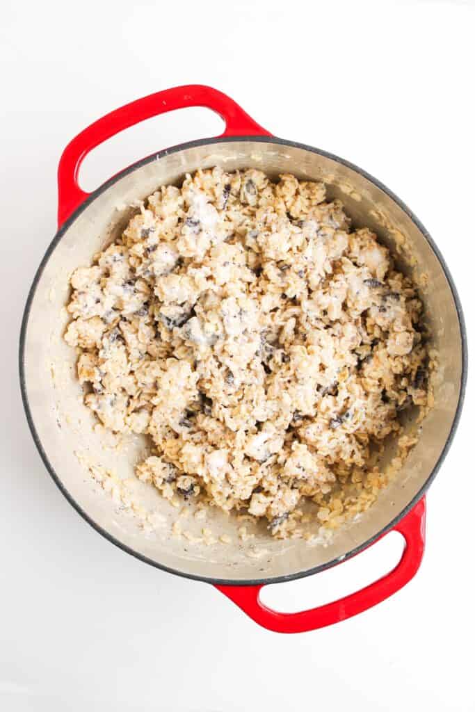 Oreo Rice Krispies batter of marshmallows, Rice Krispies, and Oreo pieces mixed in pot, overhead shot.