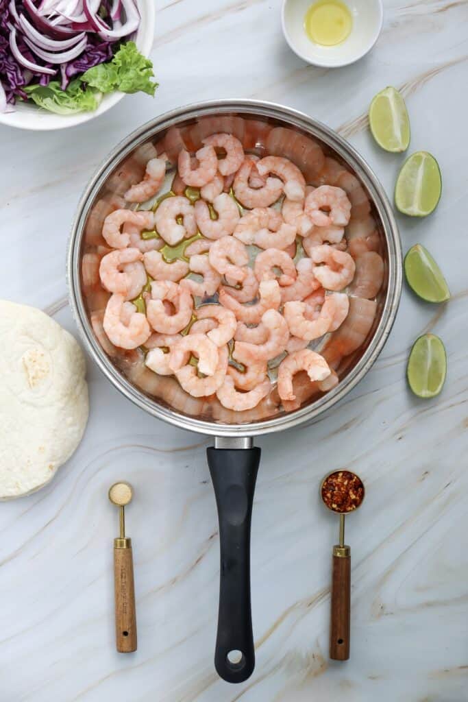 Spicy Shrimp Tacos in process, shrimp in pan, overhead shot.