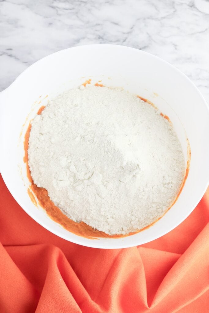 Cake Mix Pumpkin Bread, in process, flour and wet ingredients in white mixing bowl.