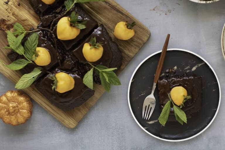 Chocolate Pumpkin Patch Brownie Cake, pieces on cutting board and on plate with fork, overhead shot.