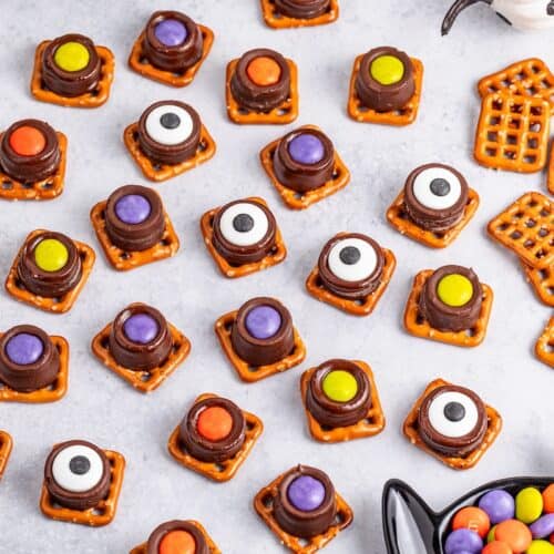 Halloween Rolo Pretzels treats next to pretzel snaps and M&M's.