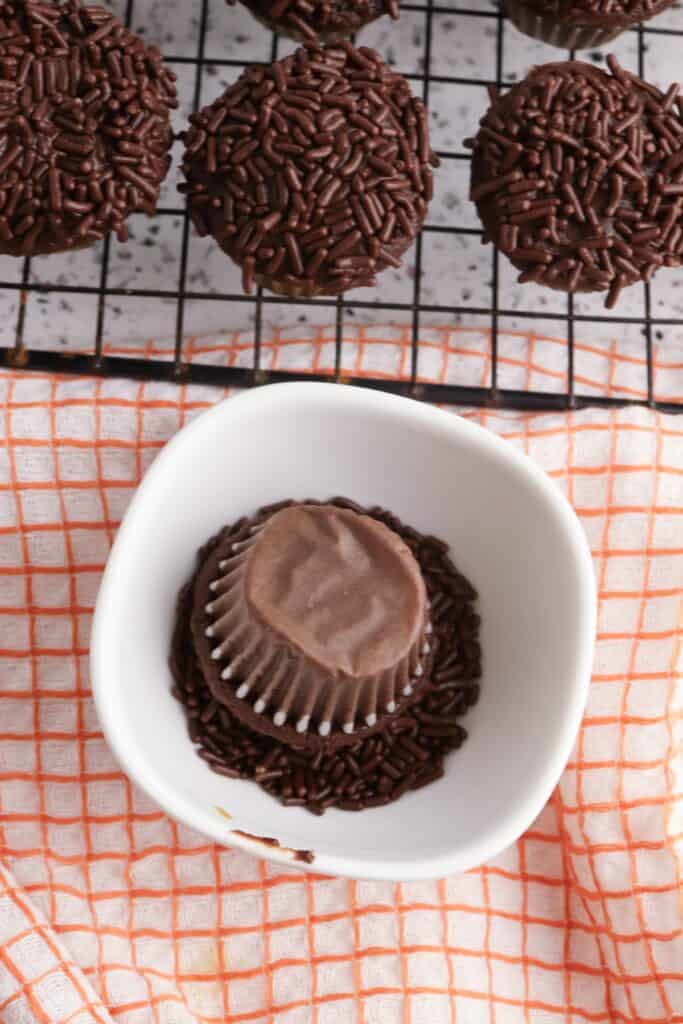 Mini Turkey Cupcakes, in process, iced chocolate cupcake dipped in chocolate sprinkles.