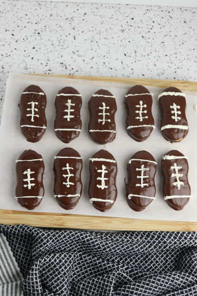 Nutter Butter Football Cookies, in process, hardening on parchment paper.