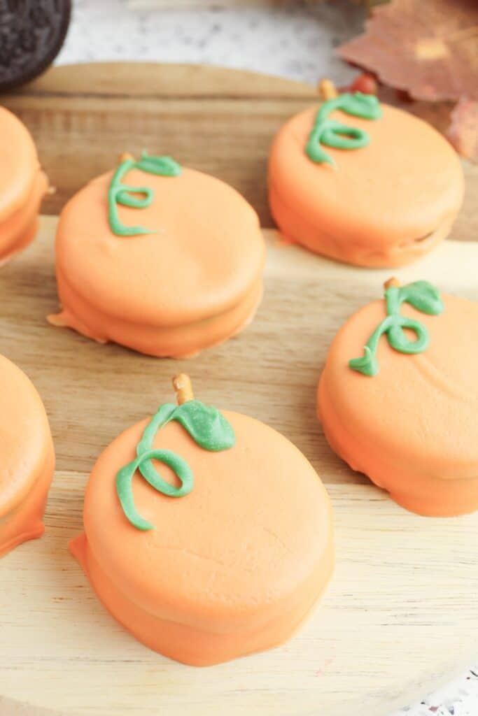 Oreo Pumpkins, close-up, on wooden cutting board.