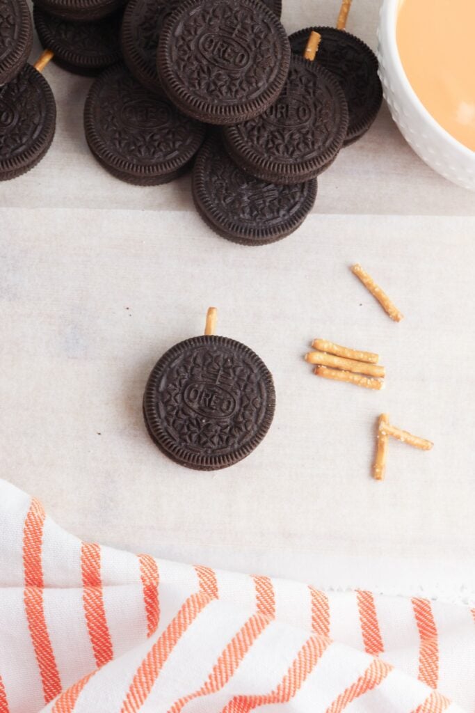 Oreo Pumpkins, in process, pretzel pieces with stacked Oreos.