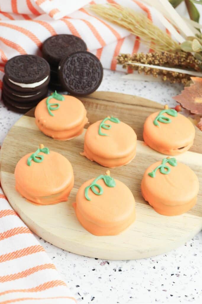 Oreo Pumpkins on wooden cutting board.