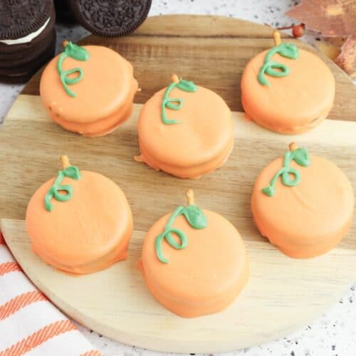 Oreo Pumpkins on wooden cutting board.