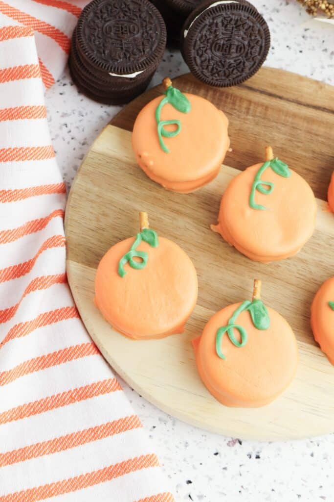 Oreo Pumpkins on wooden cutting board.