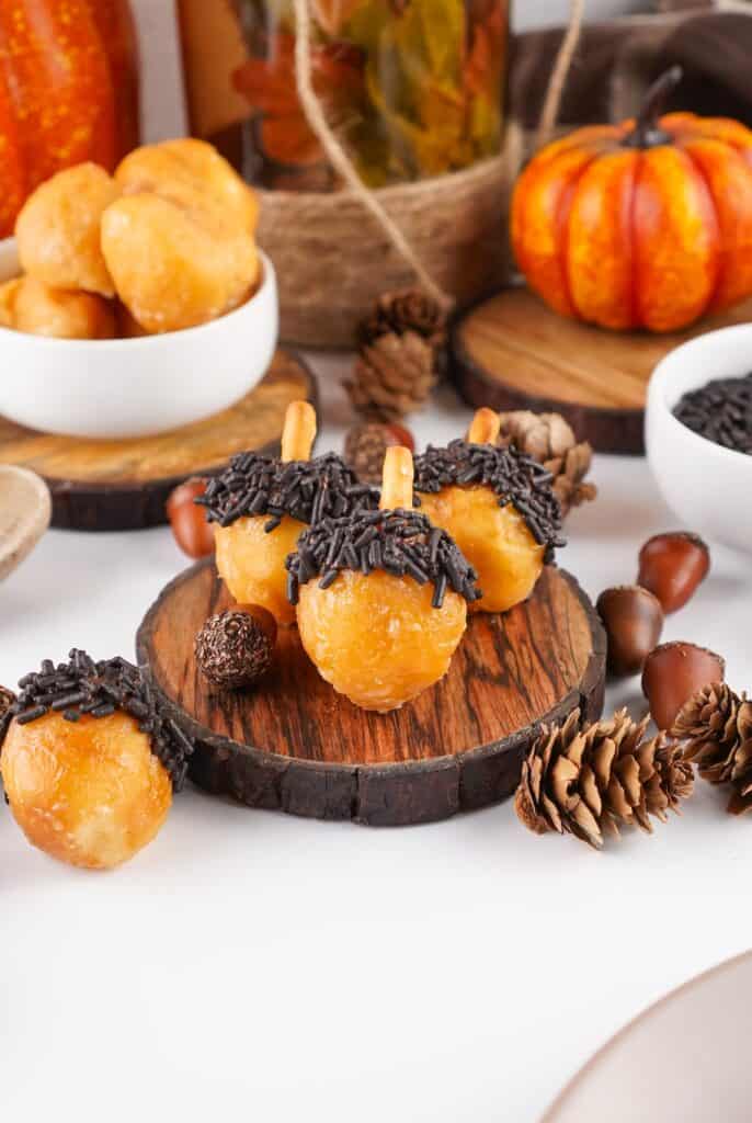 Acorn Donut Holes on small wooden display tray.
