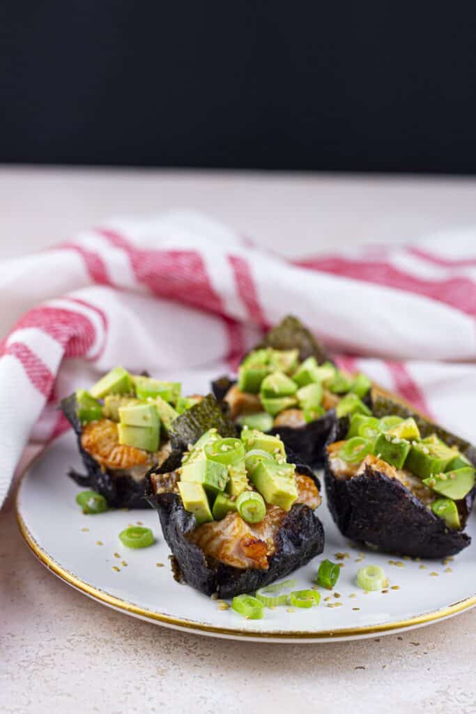 Baked Salmon Sushi Cups, plated, with red striped kitchen towel.