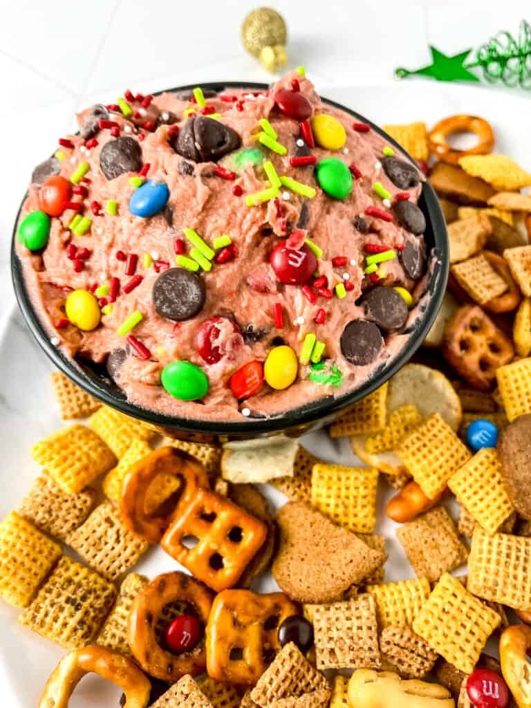 Christmas Cookie Dip with Chex mix on white tray.