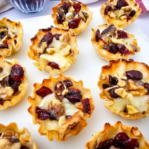 Cranberry and Walnut Brie Bites on white background.