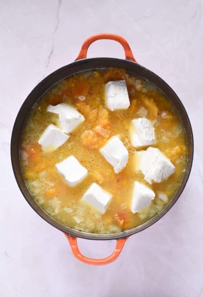 Creamy Butternut Squash Soup, in process, brown sugar, cream cheese, vegetable broth, oil, onion, butter and squash in dutch oven.