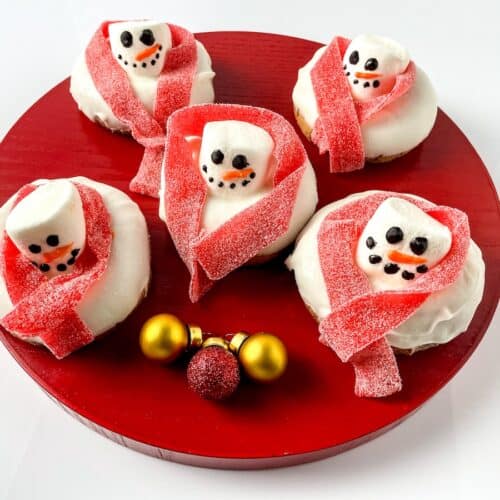Melted Snowman Donuts on round red tray.