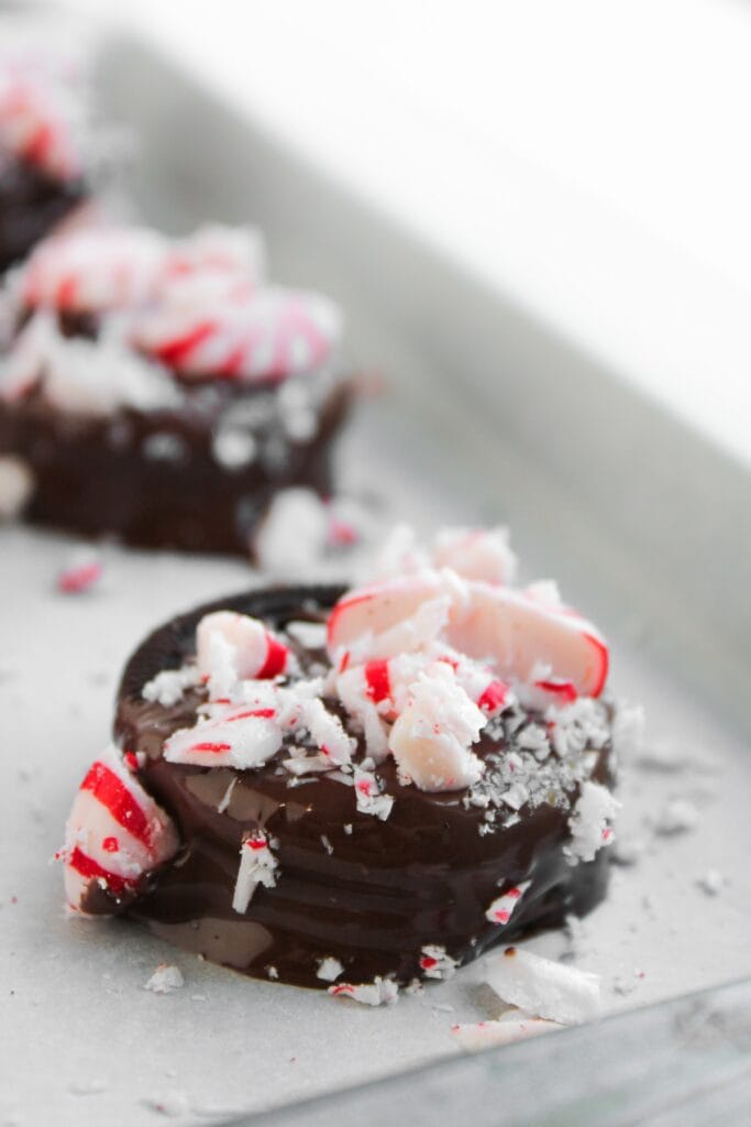 Peppermint Chocolate Covered Oreos, close-up of Oreo covered in dark chocolate and crushed peppermint candies.