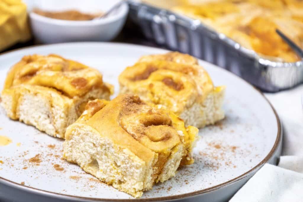 Pumpkin Cinnamon Rolls, three rolls on serving plate.