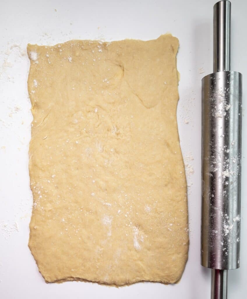 Pumpkin Cinnamon Rolls, in process, rectangular dough with rolling pin.