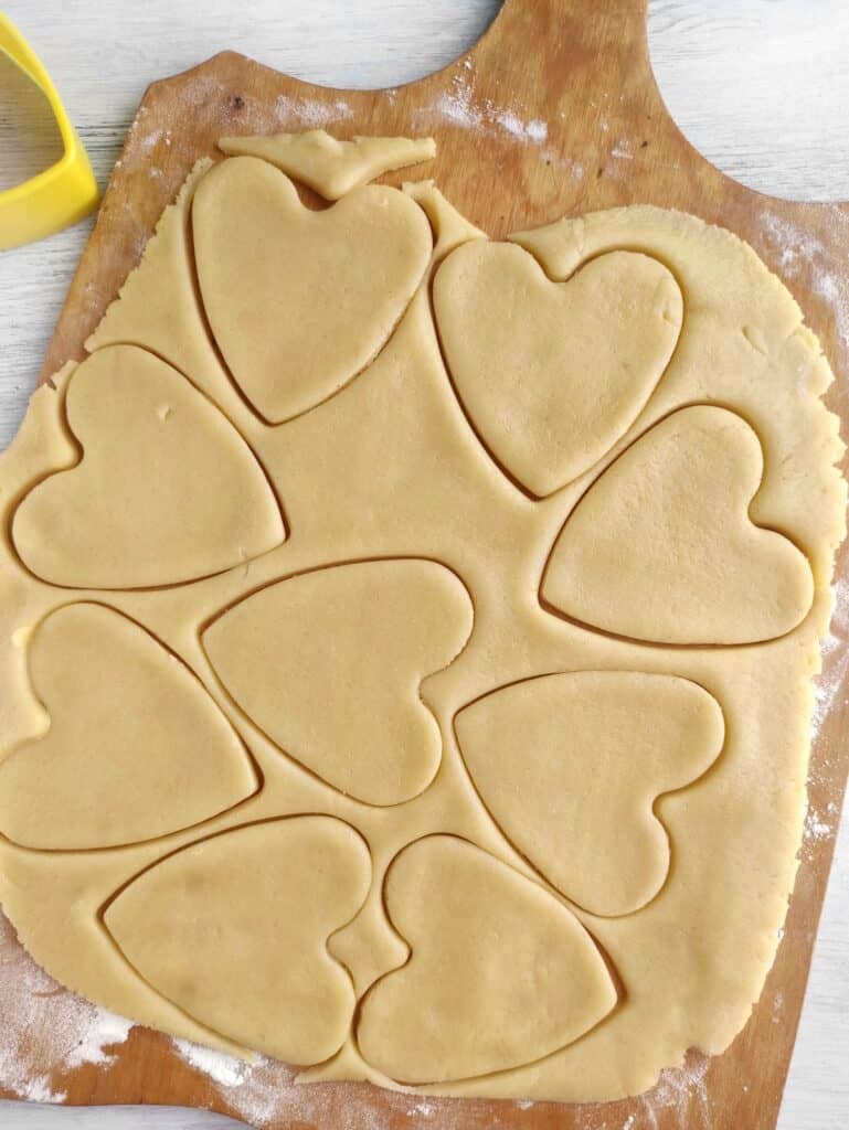 Turkey Sugar Cookies, in process, rolled dough with heart-shaped outlines made from cookie cutters.