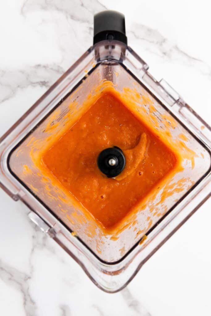 Vegan Roasted Tomato Basil Soup, in process, baked tomato halves with onions, garlic and olive oil and tomato paste, blended in blender.