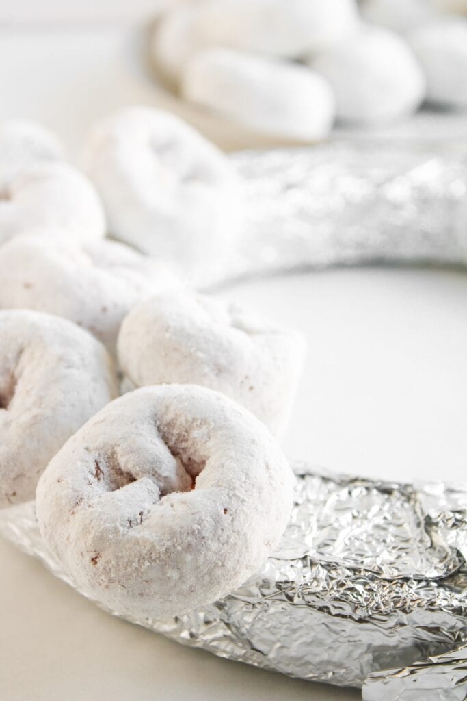 Christmas Donut Wreath, in process, adding donut holes to foil.