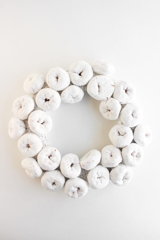 Christmas Donut Wreath, in process, mini powdered donuts added to foil.