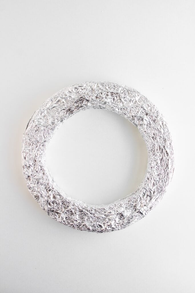 Christmas Donut Wreath, in process, foam circle wrapped in aluminum foil.