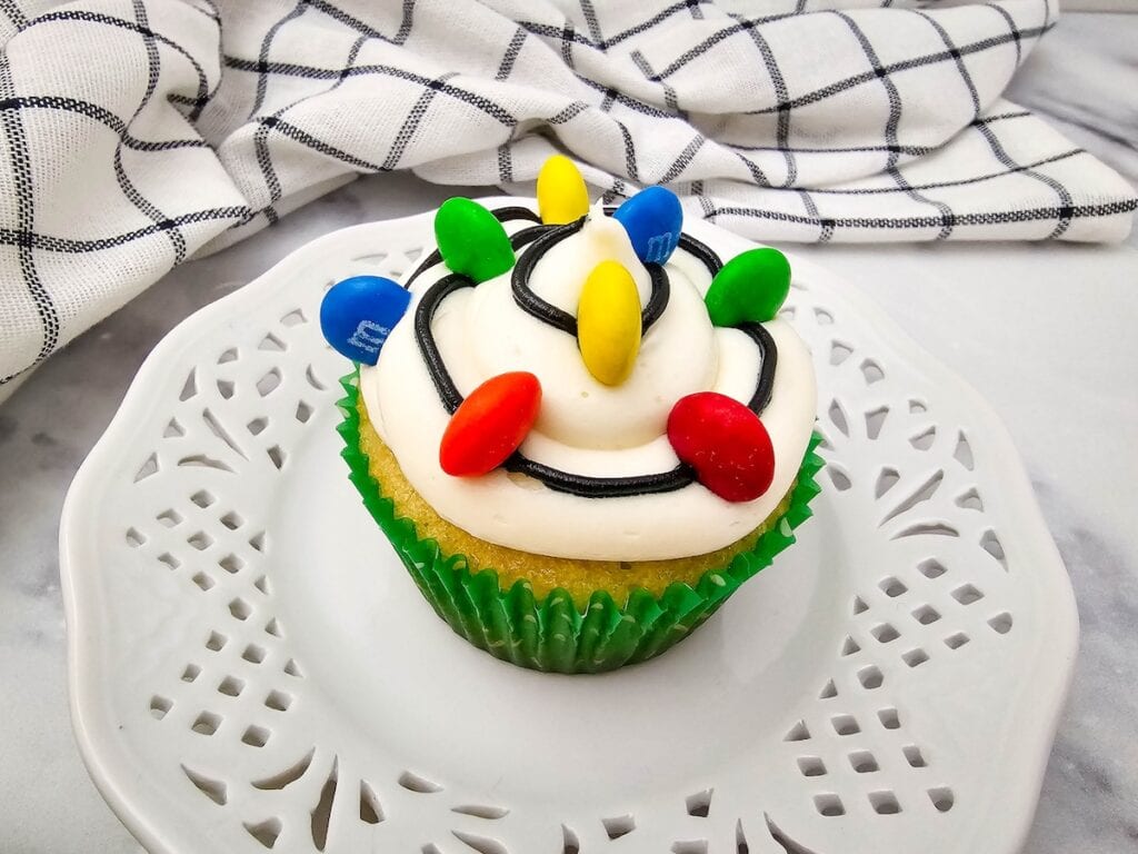 Christmas Light Cupcake on white dessert plate.