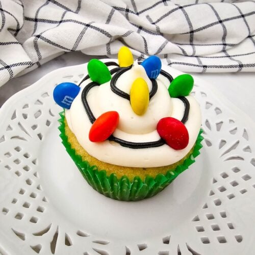 Christmas Light Cupcake on white dessert plate.