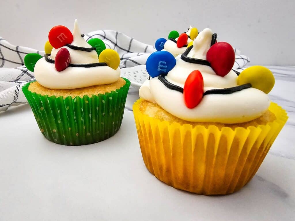 Christmas Light Cupcakes, side by side in green and yellow cupcake liners.