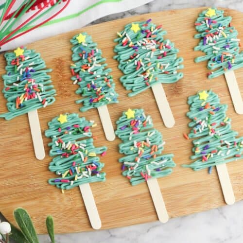Christmas Tree Pops on wooden cutting board.