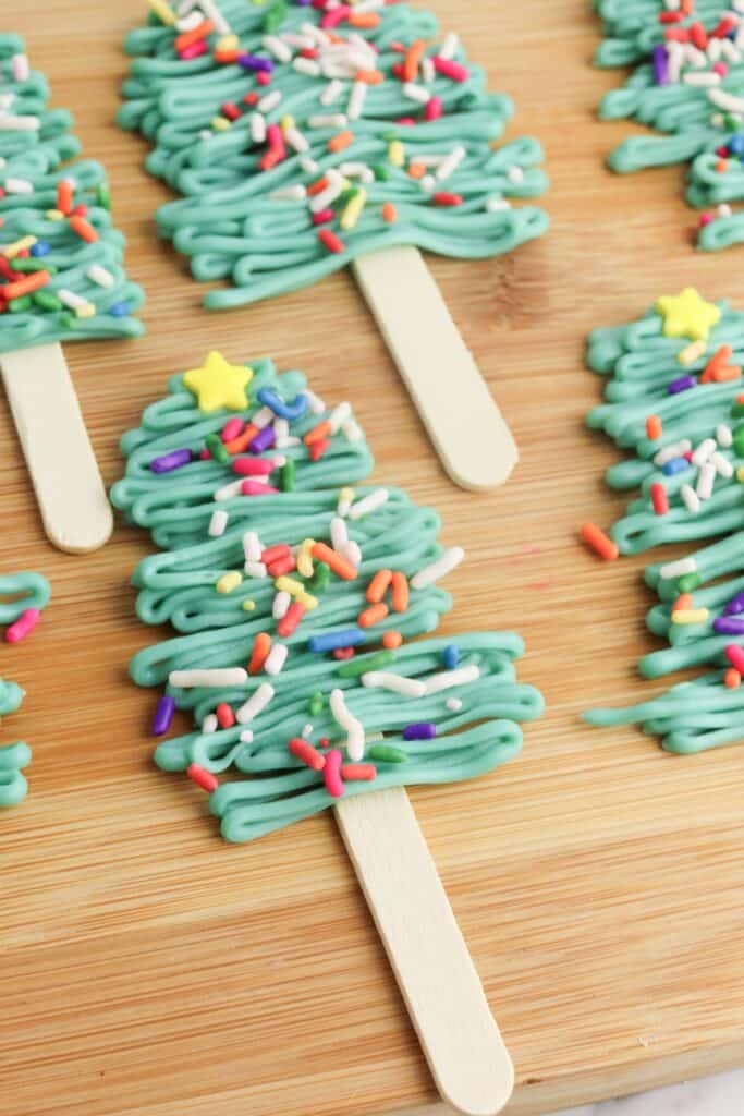 Christmas Tree Pops, close-up, on wooden cutting board.