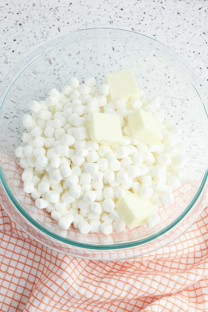 Ghost Rice Krispie Treats, in process, mini marshmallows and butter in glass mixing bowl.