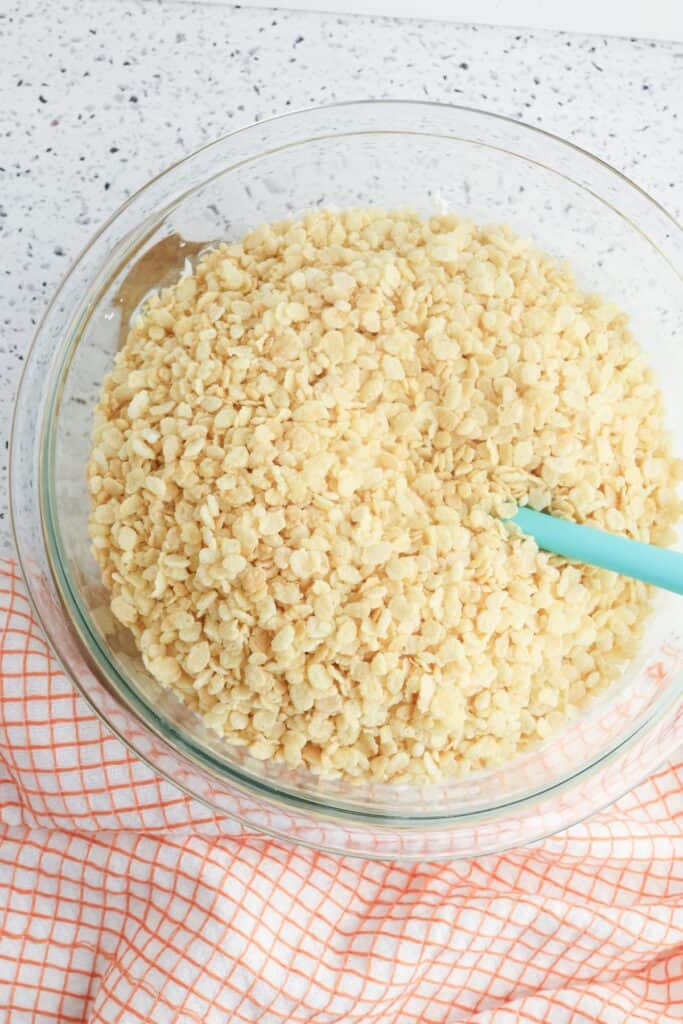 Ghost Rice Krispie Treats, in process, Rice Krispies added to mini marshmallows and butter mixture.