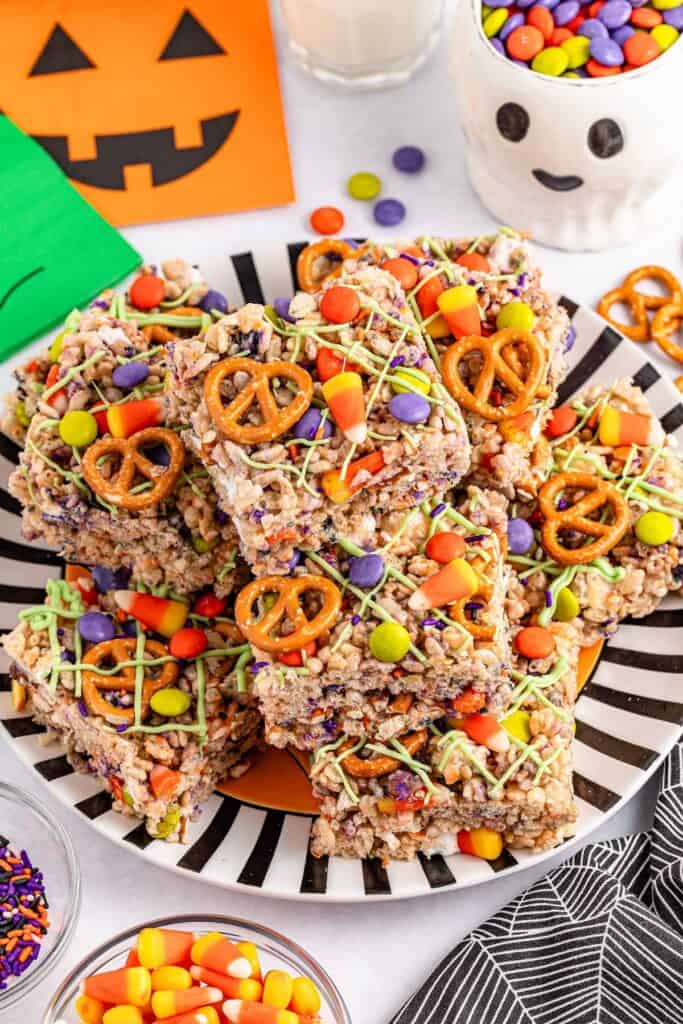 Halloween Rice Krispie Treats on black striped plate.
