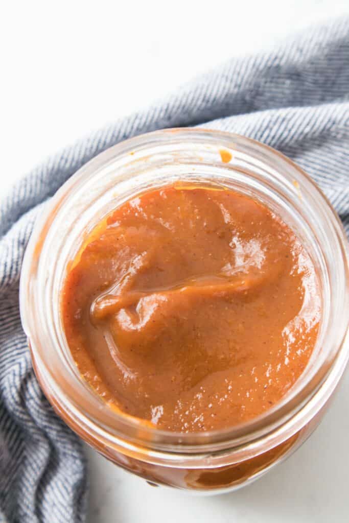 Homemade Pumpkin Butter in jar, overhead close-up.