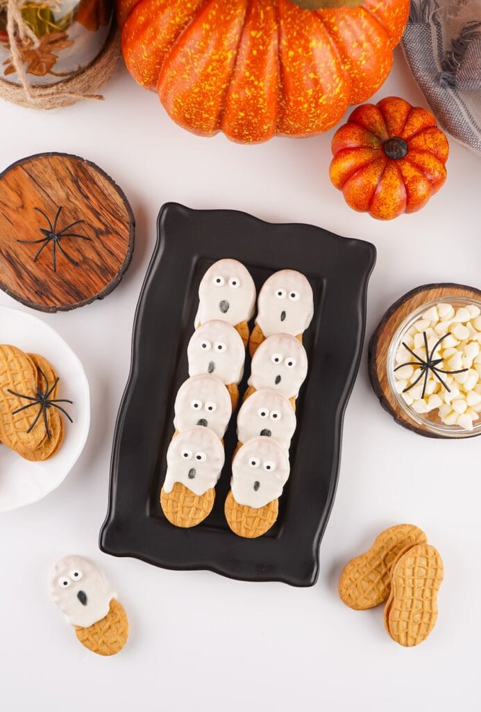 Nutter Butter Ghost Cookies on black plate.