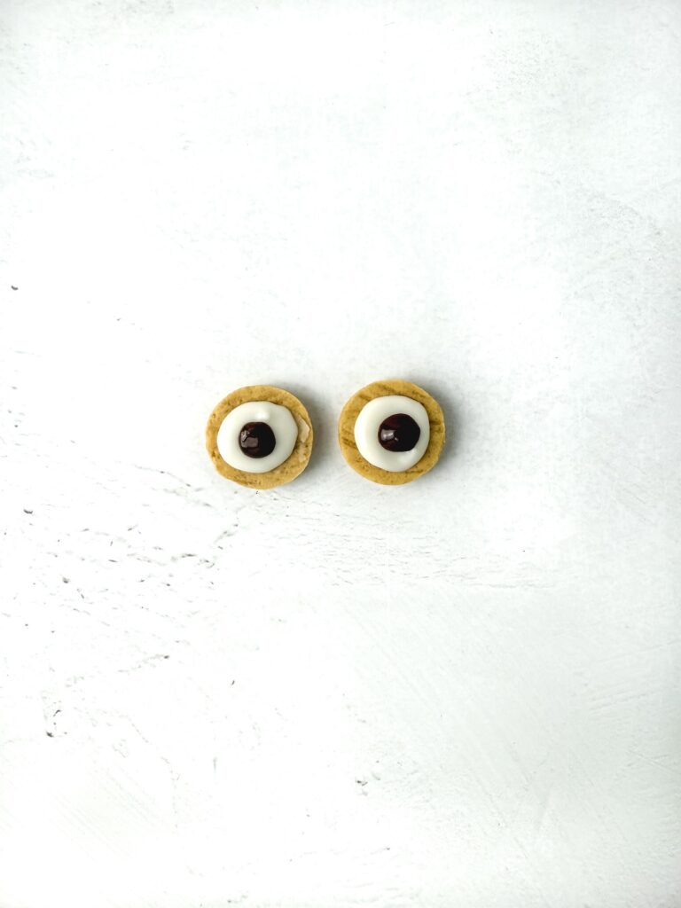 Nutter Butter Owl Cookies, in process, chocolate eyes made from mini vanilla sandwich cookie.
